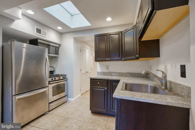 a kitchen with a refrigerator sink and microwave