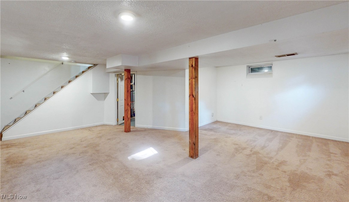 3491 Kent Road Stow, OH 44224 - Photo 27 of 40 Basement with a textured ceiling, carpet and staircase