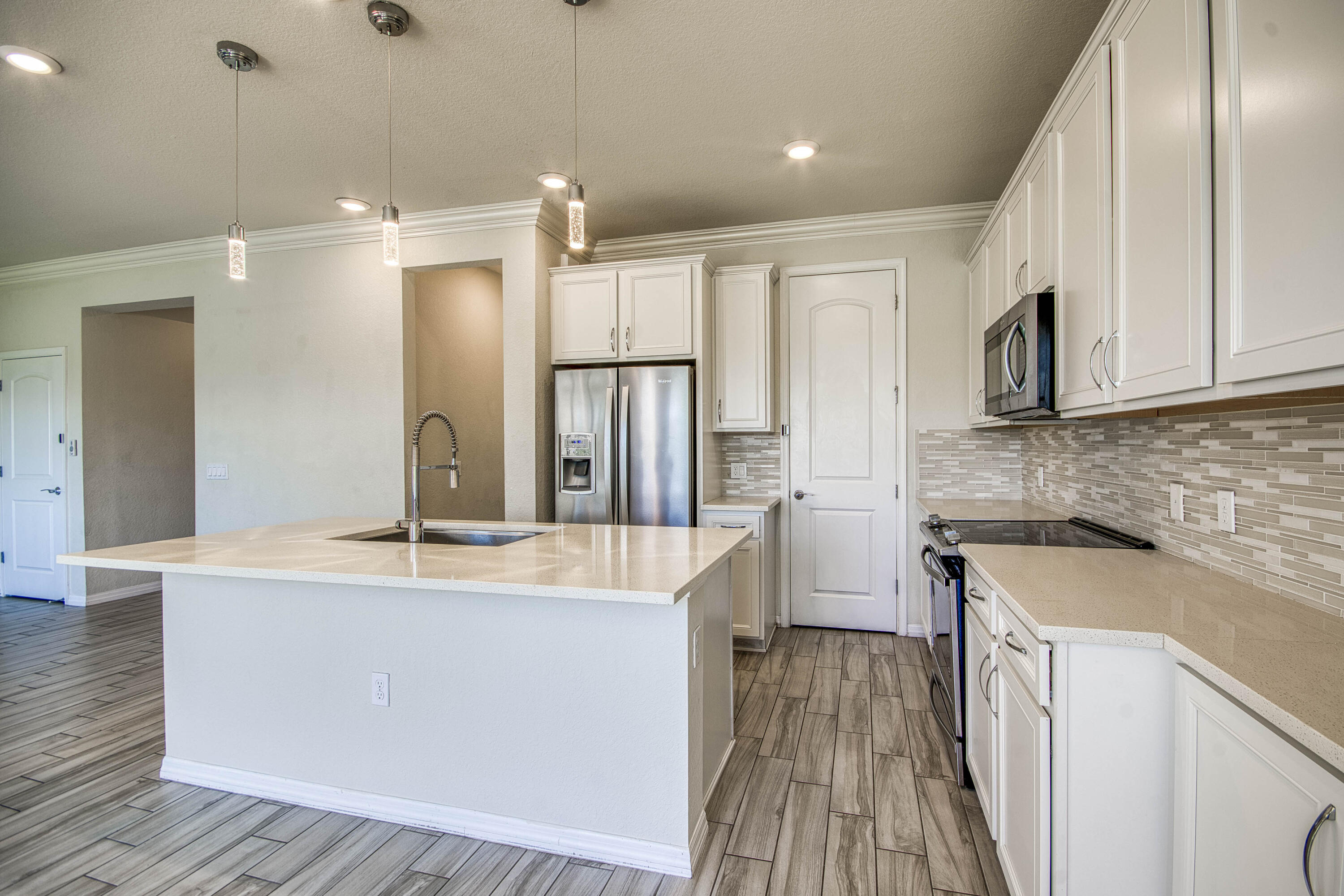 8301 Rearing Lane Lake Worth, FL 33467 - Photo 13 of 33 a kitchen with stainless steel appliances granite countertop a sink a stove and a refrigerator