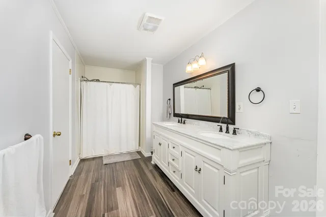 a bathroom with a double vanity sink and mirror