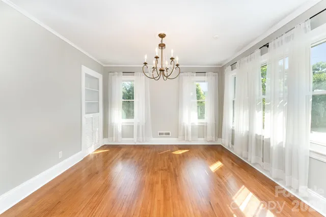a view of a room with wooden floor windows and entryway