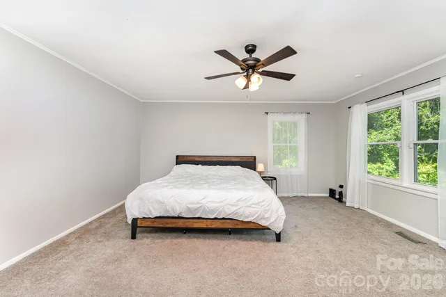 a bedroom with a bed and window