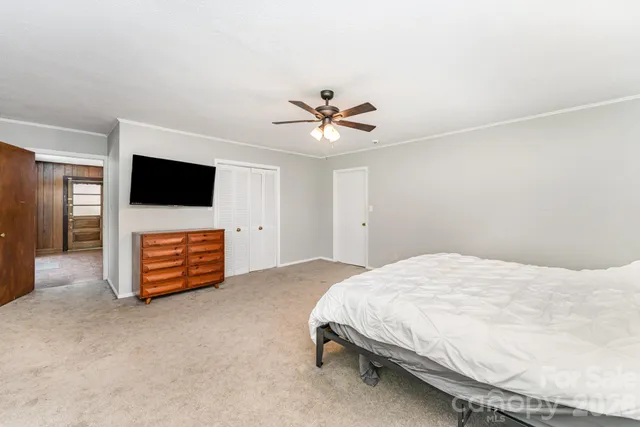 a bedroom with a bed and a television