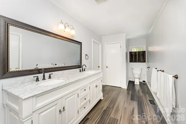 a bathroom with a double vanity sink and a mirror