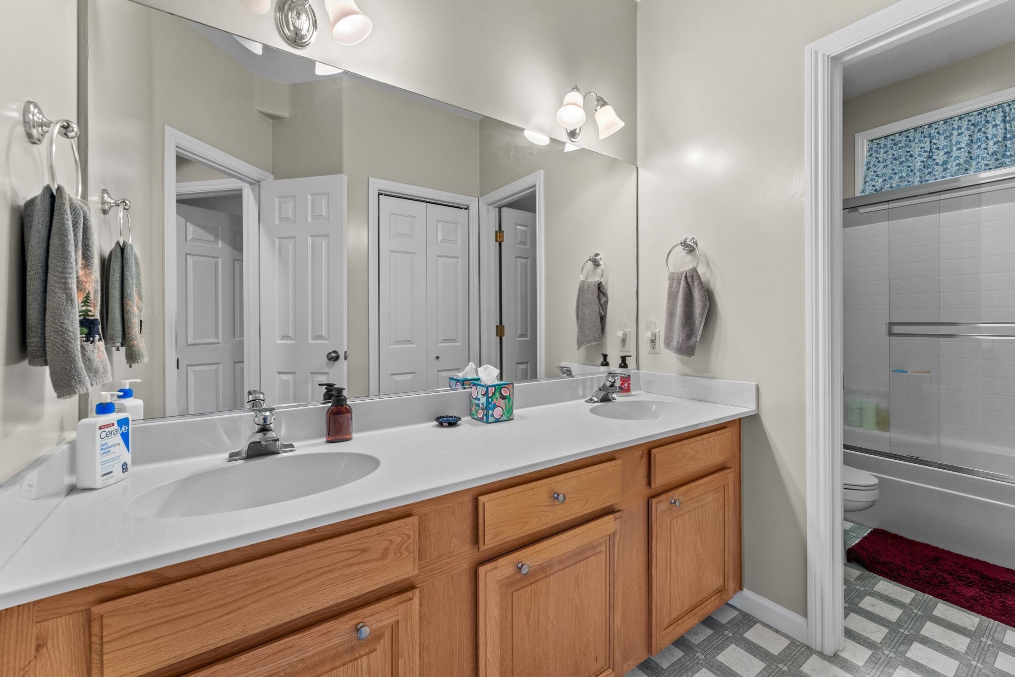 1341 Valley Ranch Drive Clio, CA 96106 - Photo 24 of 50 a bathroom with double vanity sinks a vanity and a mirror