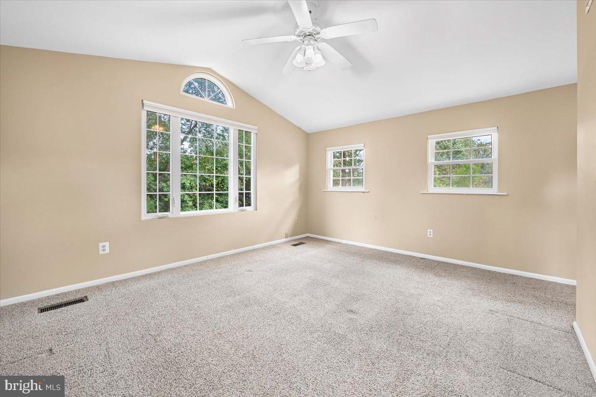10101 Portland Road Silver Spring, MD 20901 - Photo 15 of 33 an empty room with windows and fan