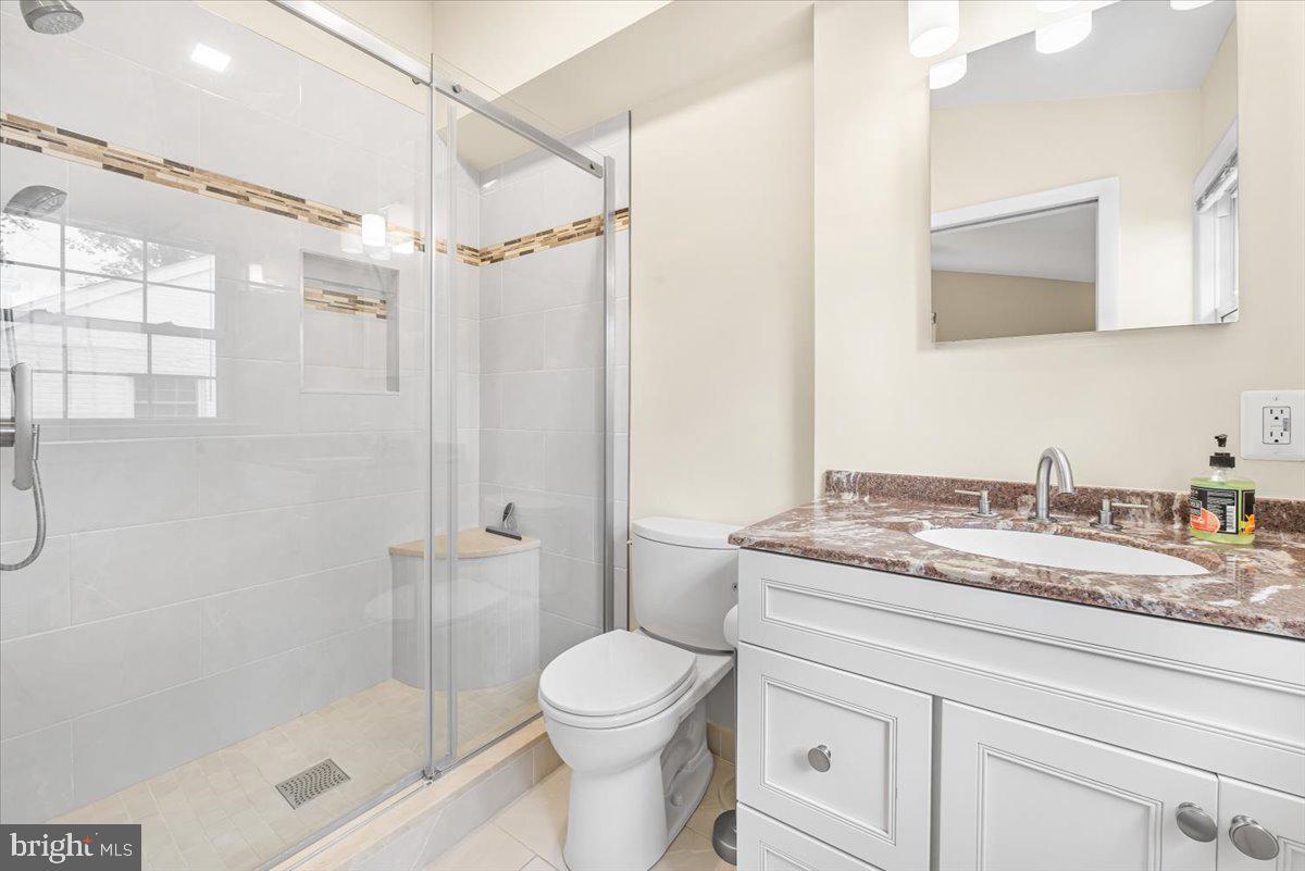10101 Portland Road Silver Spring, MD 20901 - Photo 16 of 33 a bathroom with a granite countertop sink toilet and shower