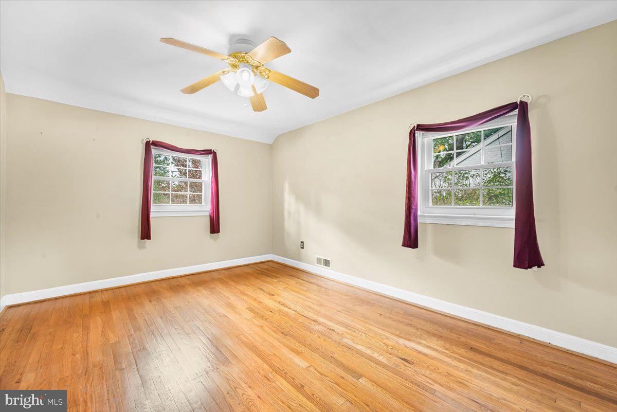 10101 Portland Road Silver Spring, MD 20901 - Photo 19 of 33 a view of an empty room with wooden floor and a window