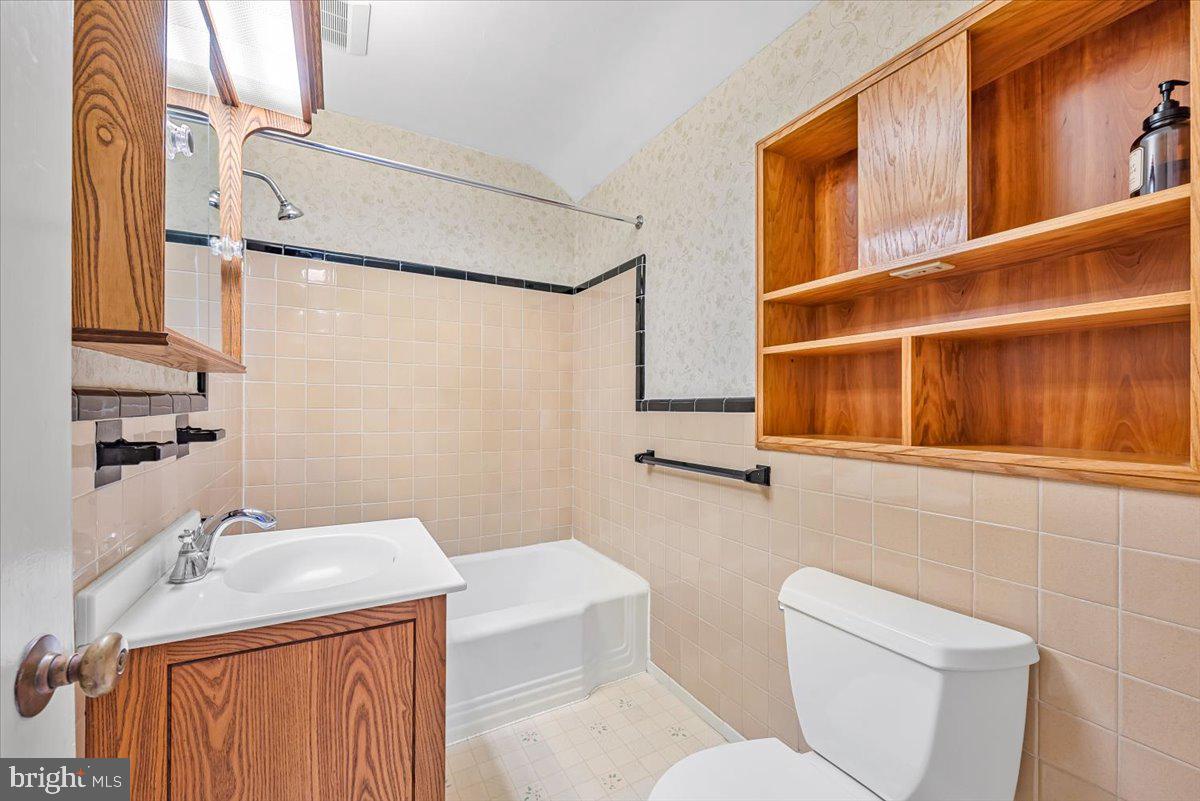 10101 Portland Road Silver Spring, MD 20901 - Photo 22 of 33 a bathroom with a sink and mirror