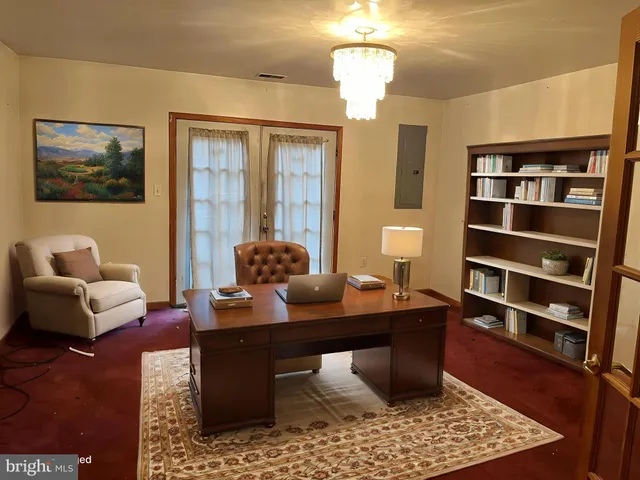 a room with a couch and a bookshelf