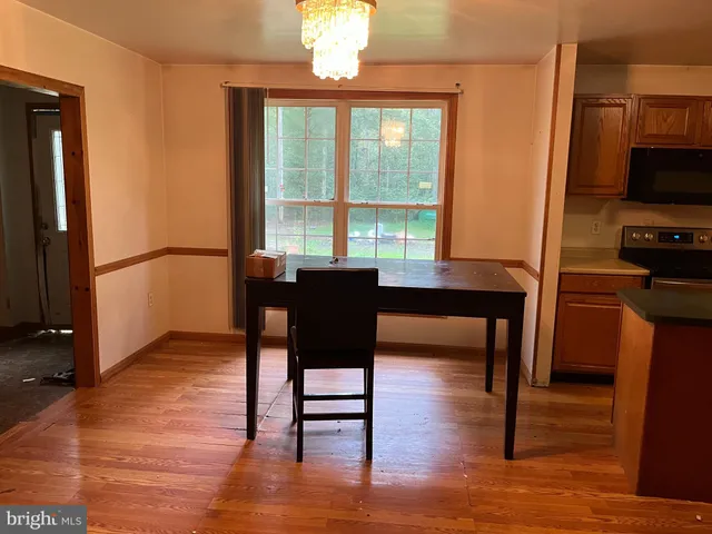 a dining room with furniture and a window
