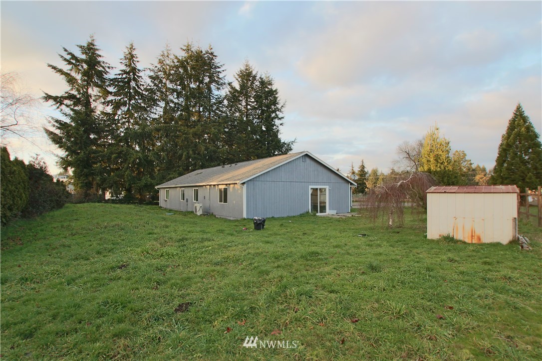 10241 183rd Way Southwest, Unit A & B Rochester, WA 98579 - Photo 22 of 22 a house with green field in front of it