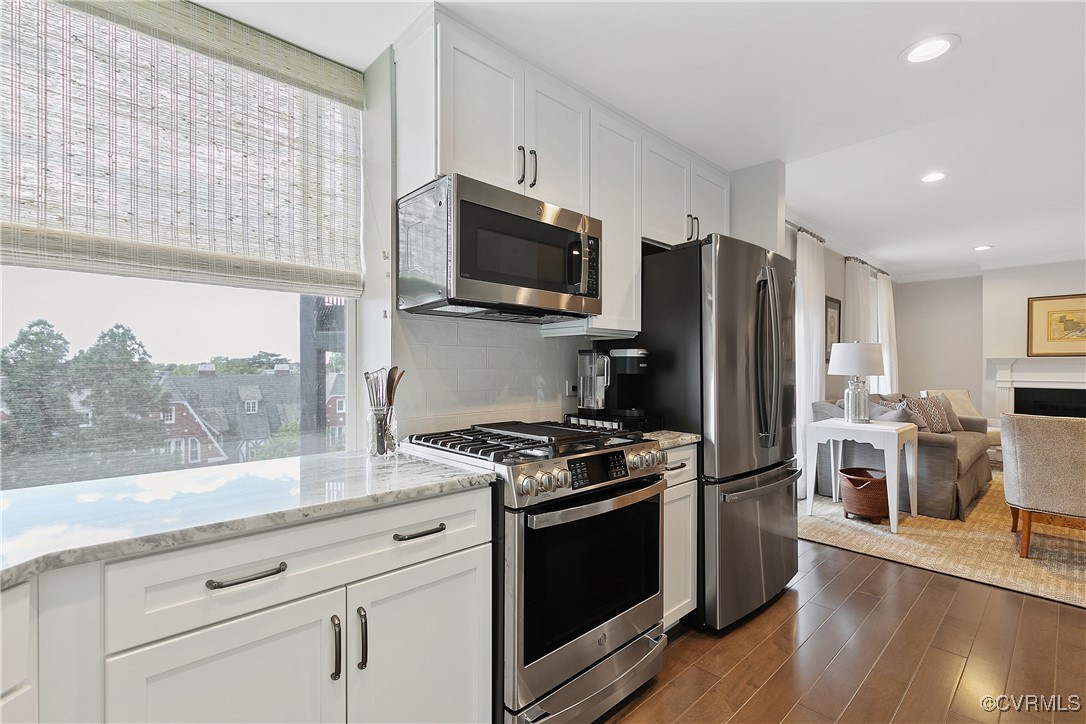 413 Stuart Circle, Unit 5E Richmond, VA 23220 - Photo 17 of 44 a kitchen with stainless steel appliances a refrigerator stove and microwave