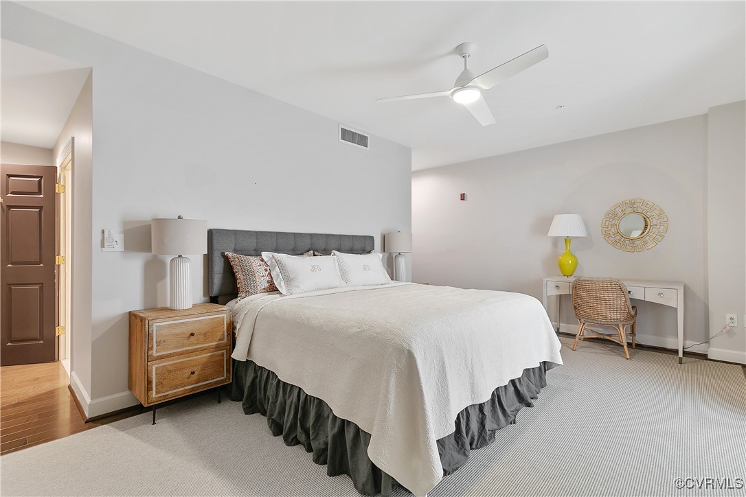 413 Stuart Circle, Unit 5E Richmond, VA 23220 - Photo 21 of 44 a bedroom with a bed and a chandelier