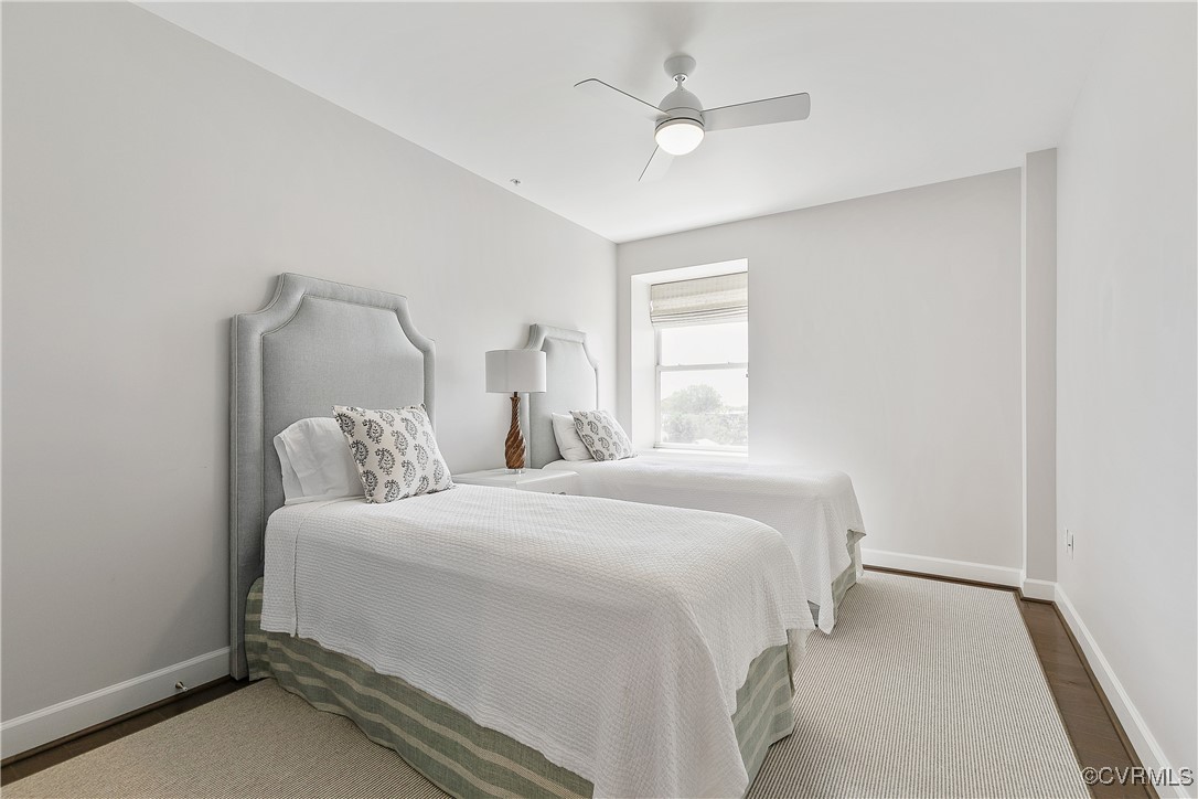 413 Stuart Circle, Unit 5E Richmond, VA 23220 - Photo 28 of 44 a bedroom with a large bed and a ceiling fan