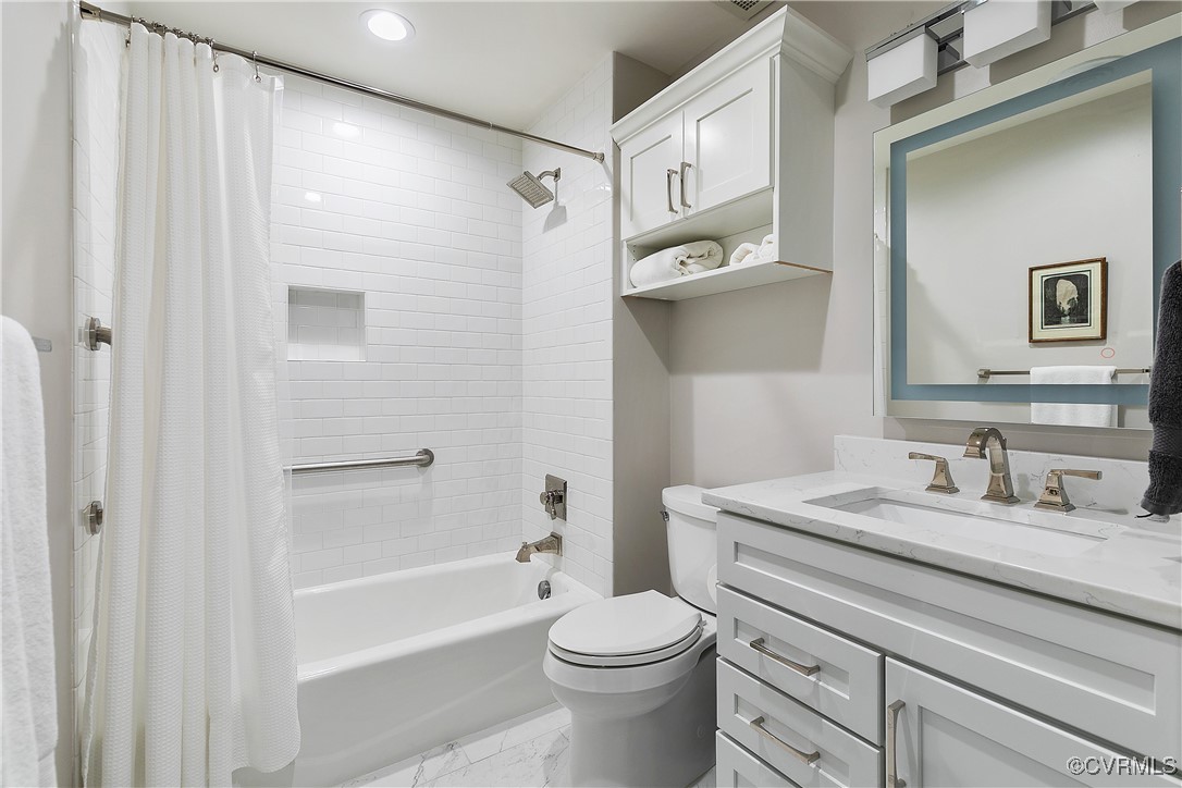 413 Stuart Circle, Unit 5E Richmond, VA 23220 - Photo 30 of 44 a bathroom with a sink a toilet and shower