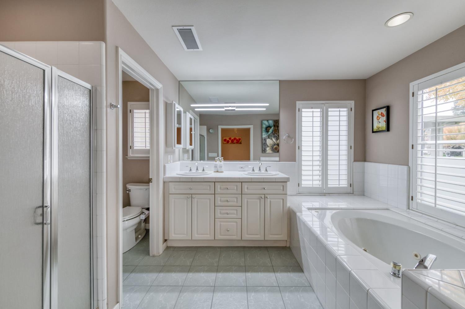 3014 West Brompton Lane Fresno, CA 93711 - Photo 41 of 71 Main bath downstairs. Spa tub. Water closet. Double sinks.