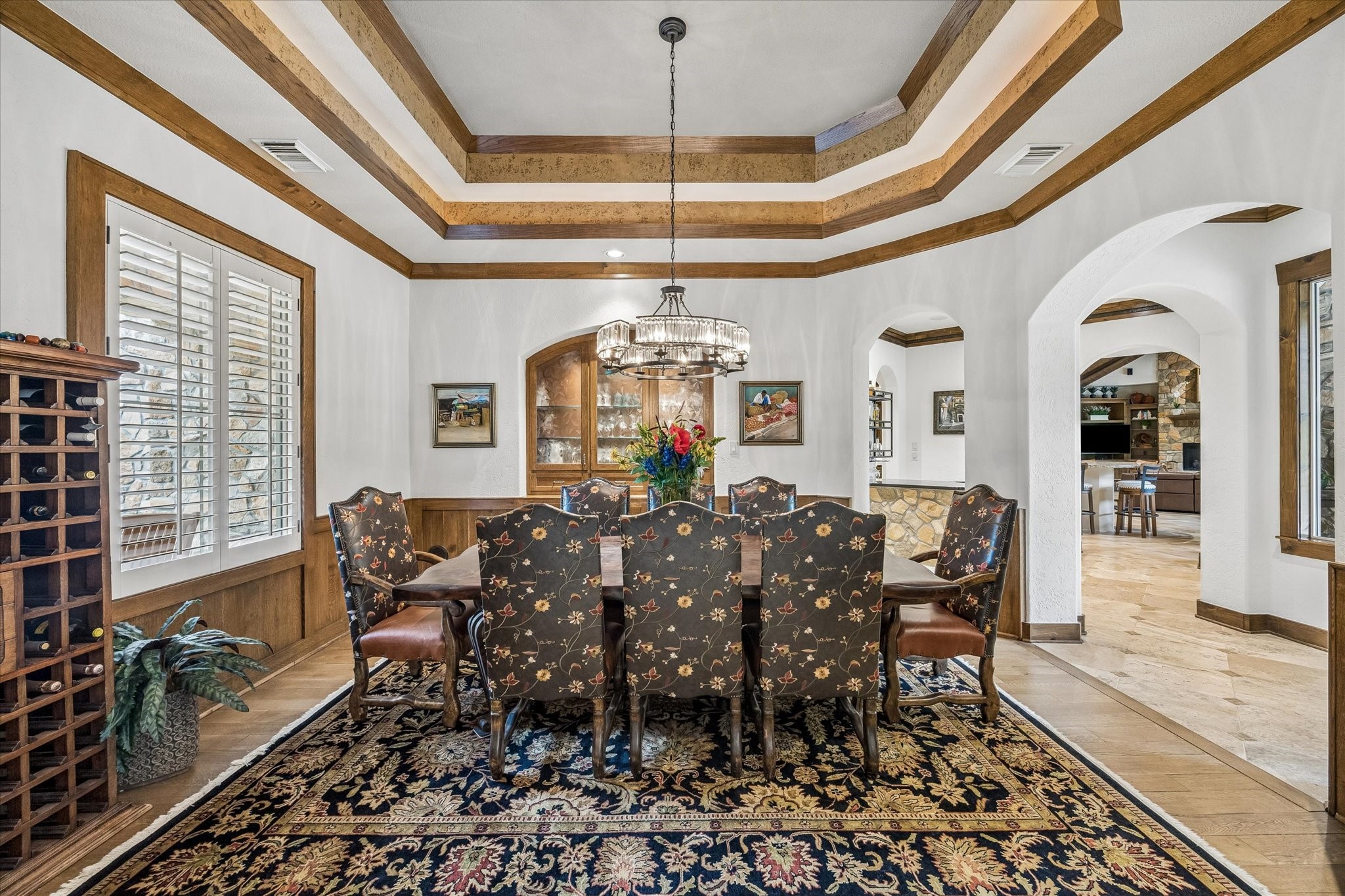 32102 Fulbrook Commons Fulshear, TX 77441 - Photo 11 of 50 Intricate ceiling treatments and graceful archways lend a refined atmosphere to this formal dining space. Front facing windows with plantation shutters, a built in storage cabinet with lighting and shelving, and rich wood paneling add elegance to the formal dining room.