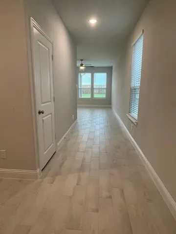 an empty room with windows and closet