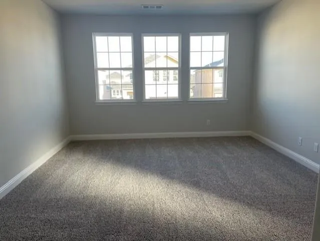 a kitchen with granite countertop a stove top oven a sink a window and a counter top space