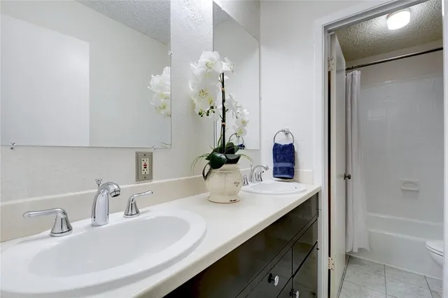 a bathroom with a sink double vanity and a mirror