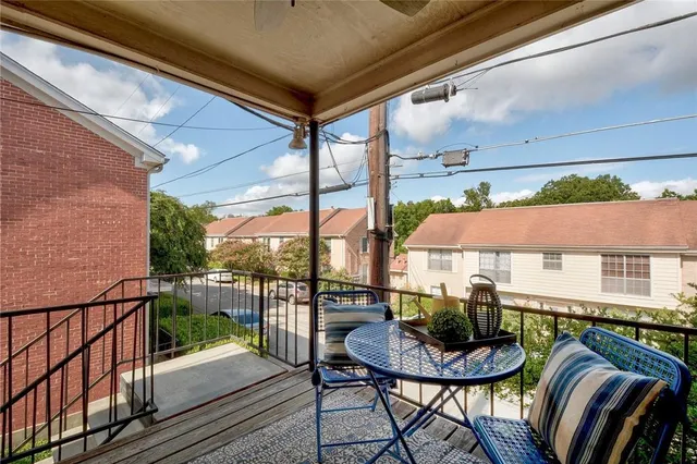 a view of balcony with chairs and table