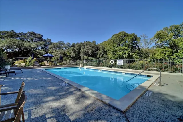 a view of a swimming pool with an outdoor seating