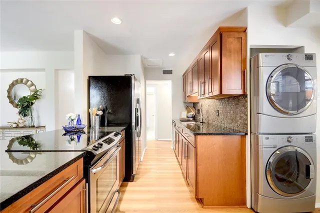 a kitchen with stainless steel appliances granite countertop a sink and cabinets