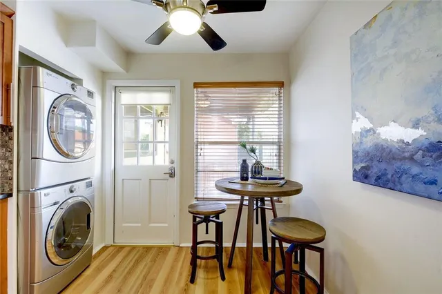 a view of a dining room with furniture a chandelier and wooden floor