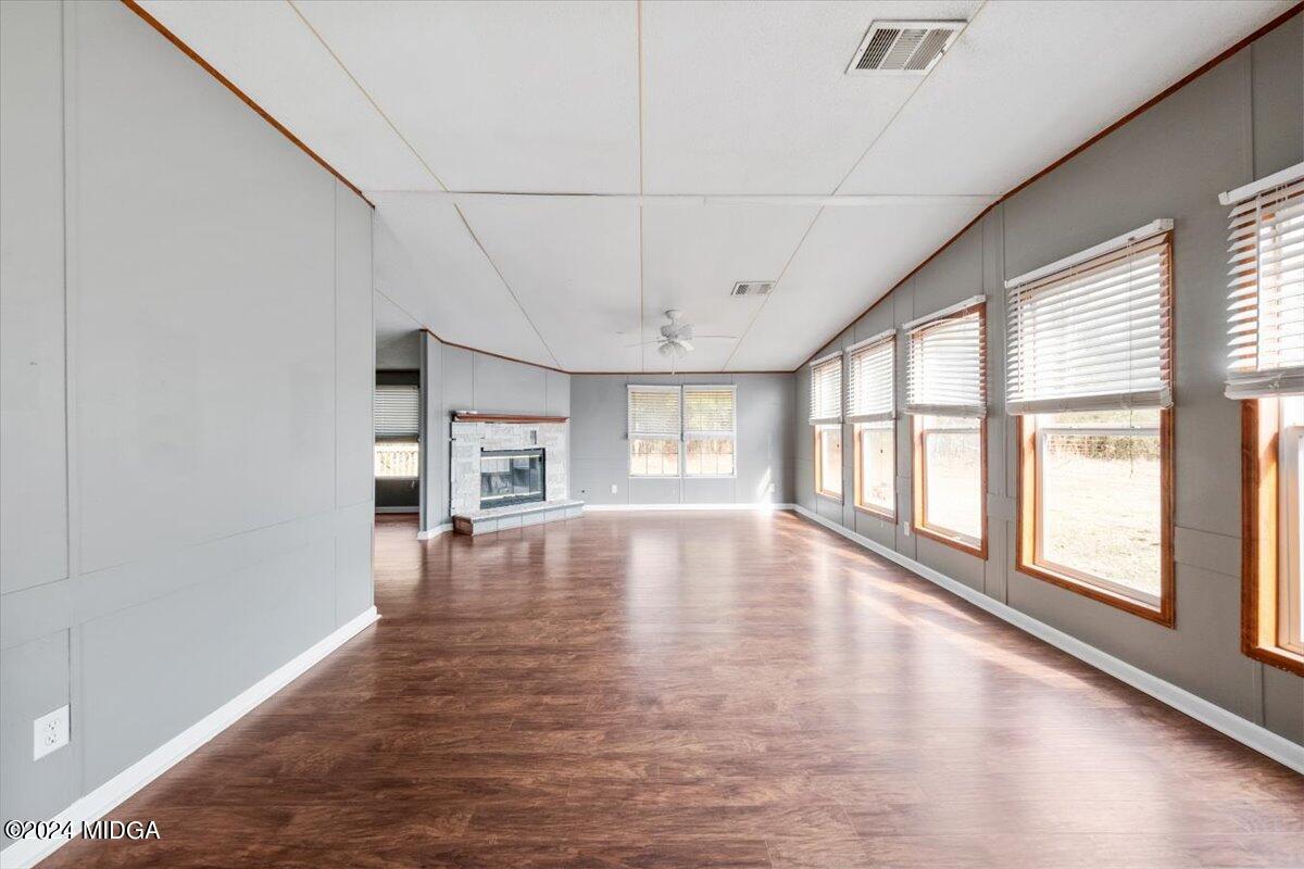 647 Gose Road Forsyth, GA 31029 - Photo 11 of 34 a view of empty room with wooden floor and fan