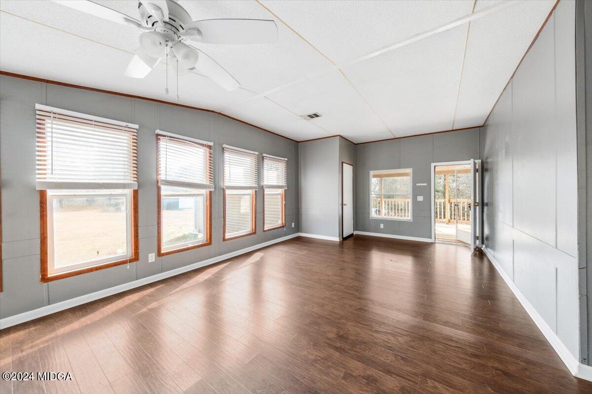 647 Gose Road Forsyth, GA 31029 - Photo 13 of 34 a view of an empty room with wooden floor and a window