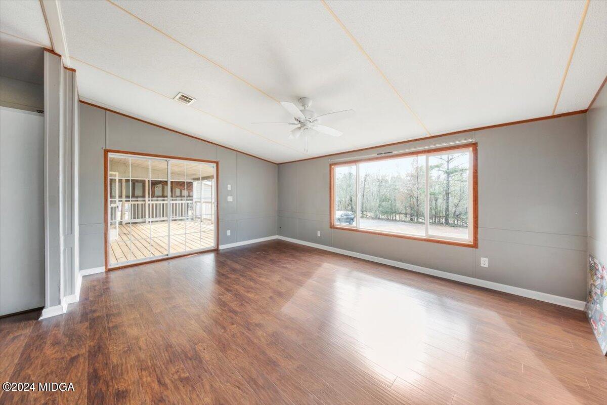 647 Gose Road Forsyth, GA 31029 - Photo 14 of 34 a view of an empty room with a window and wooden floor