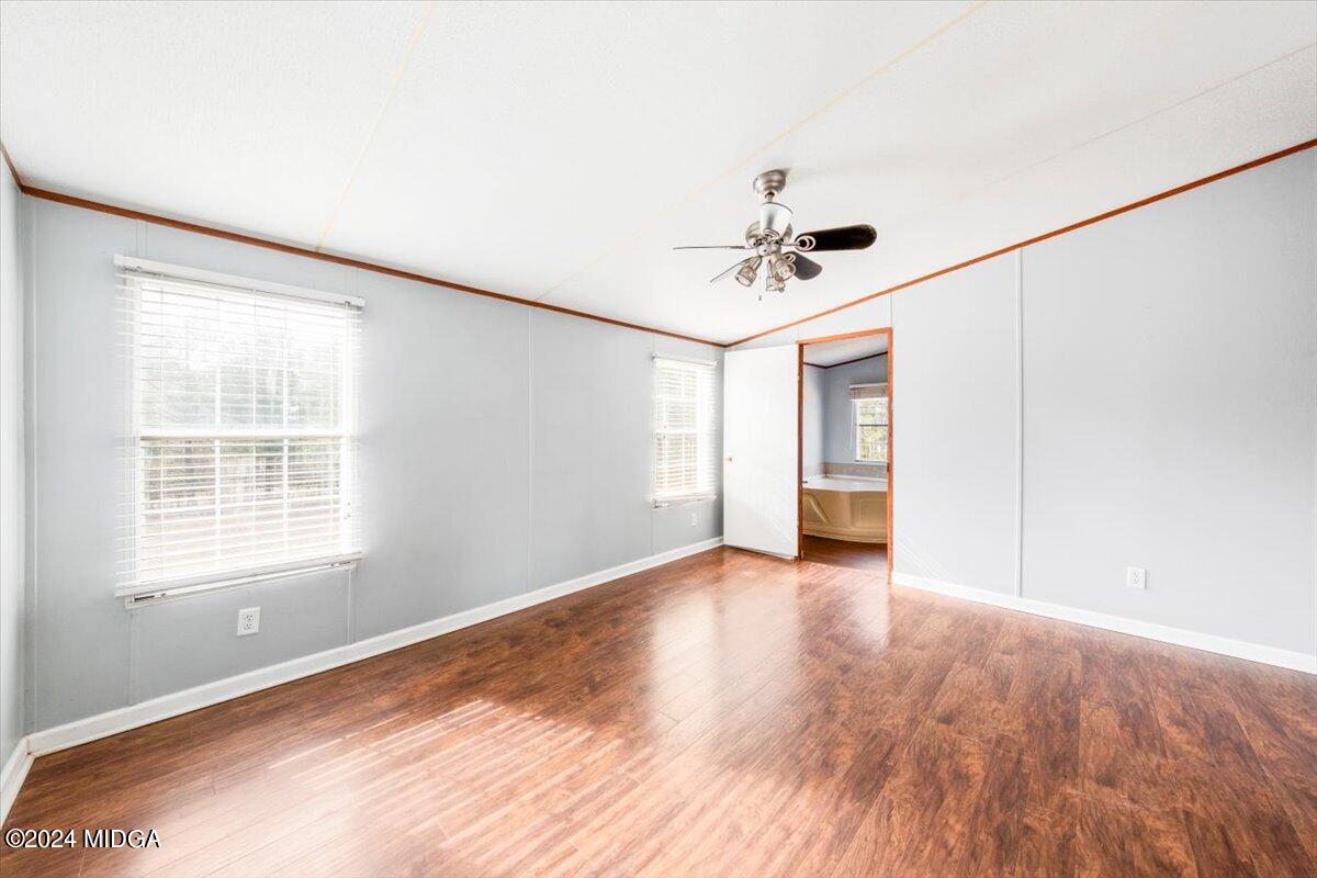 647 Gose Road Forsyth, GA 31029 - Photo 16 of 34 a view of an empty room with a window and wooden floor