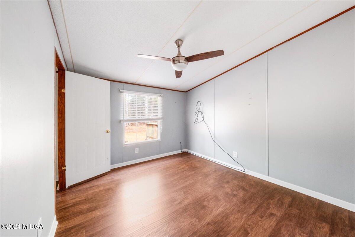647 Gose Road Forsyth, GA 31029 - Photo 20 of 34 a view of empty room with wooden floor and fan