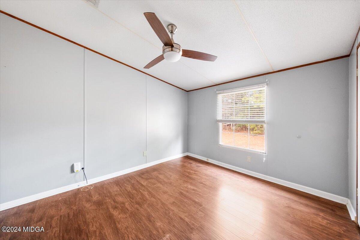 647 Gose Road Forsyth, GA 31029 - Photo 23 of 34 a view of an empty room with wooden floor and a window
