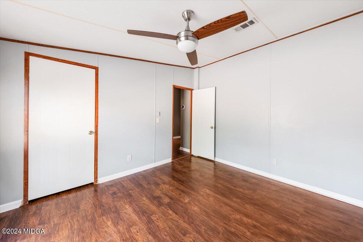 647 Gose Road Forsyth, GA 31029 - Photo 24 of 34 an empty room with wooden floor and a ceiling fan