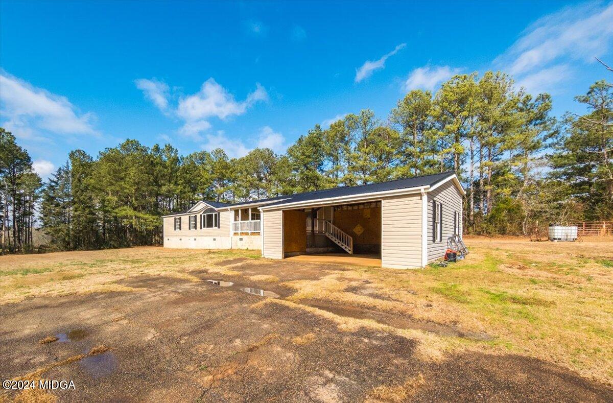 647 Gose Road Forsyth, GA 31029 - Photo 28 of 34 a view of a house with a yard