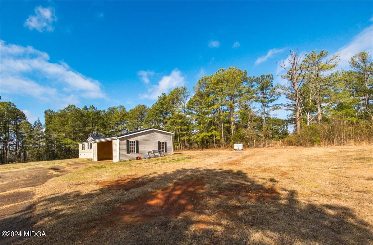647 Gose Road Forsyth, GA 31029 - Photo 30 of 34 a view of a house with a yard