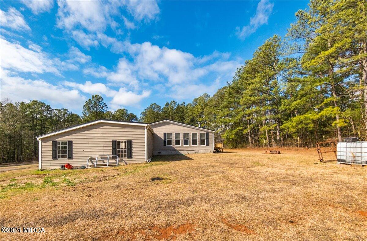 647 Gose Road Forsyth, GA 31029 - Photo 31 of 34 a view of a house with a backyard