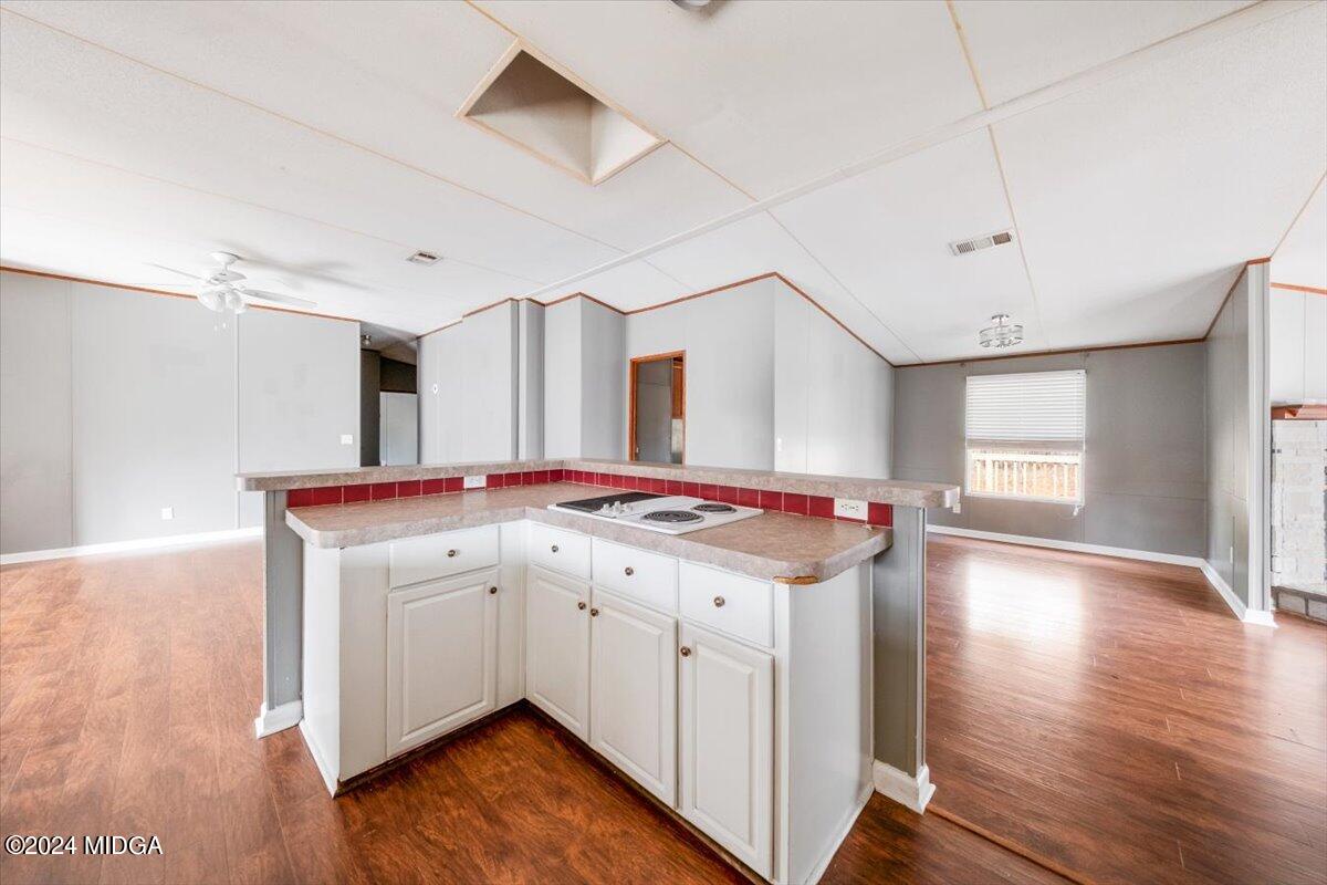 647 Gose Road Forsyth, GA 31029 - Photo 7 of 34 a kitchen with a sink cabinets and wooden floor