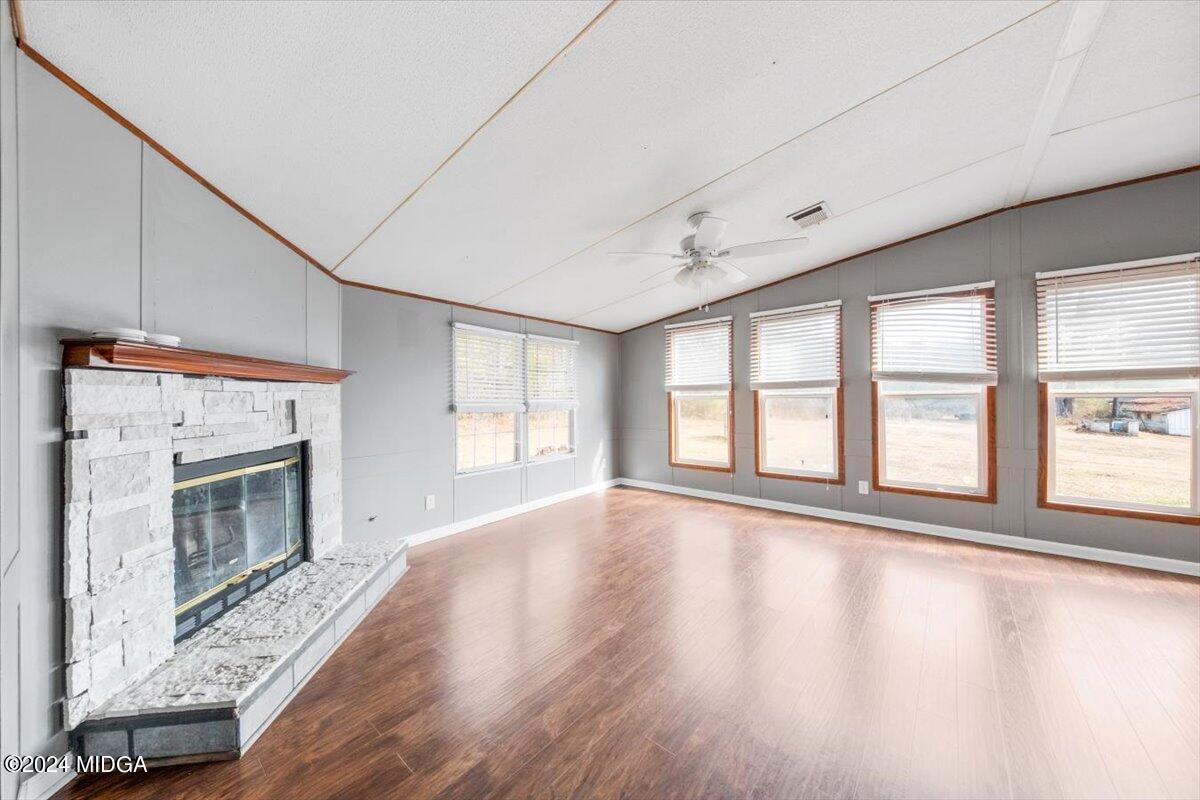 647 Gose Road Forsyth, GA 31029 - Photo 8 of 34 a view of an empty room with a fireplace and a window