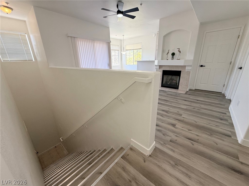 9050 West Warm Springs Road, Unit 2002 Las Vegas, NV 89148 - Photo 8 of 46 This inviting space features a cozy fireplace and modern flooring, creating a warm and stylish atmosphere.