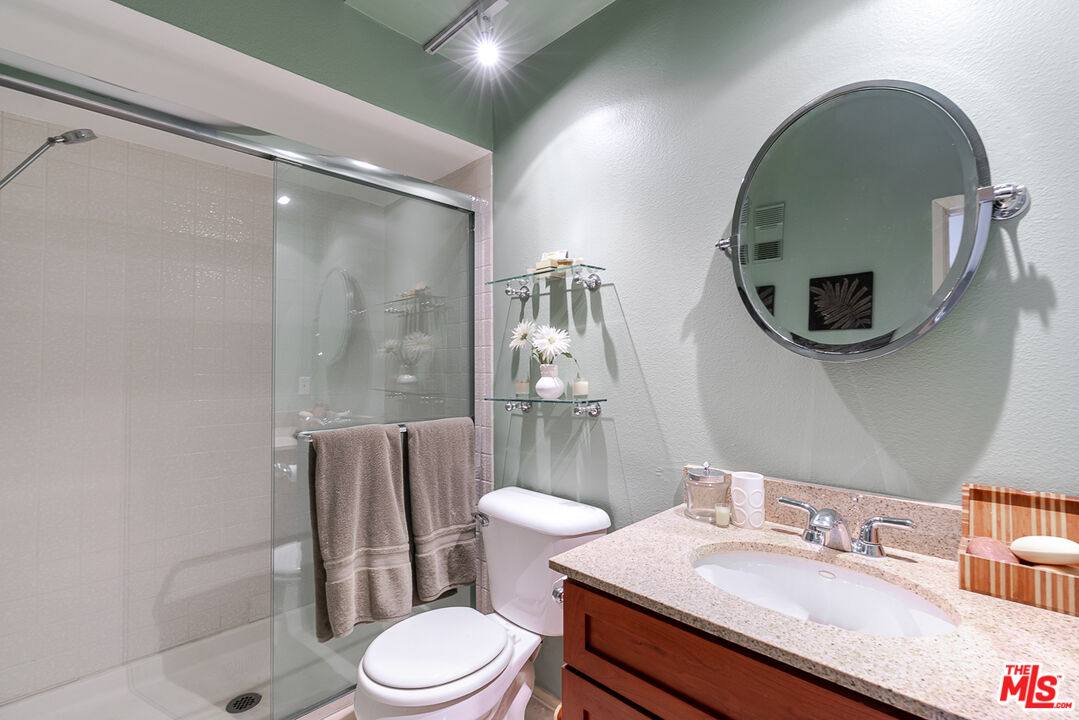 11322 Camarillo Street, Unit 201 Toluca Lake, CA 91602 - Photo 12 of 20 a bathroom with a sink a toilet and shower