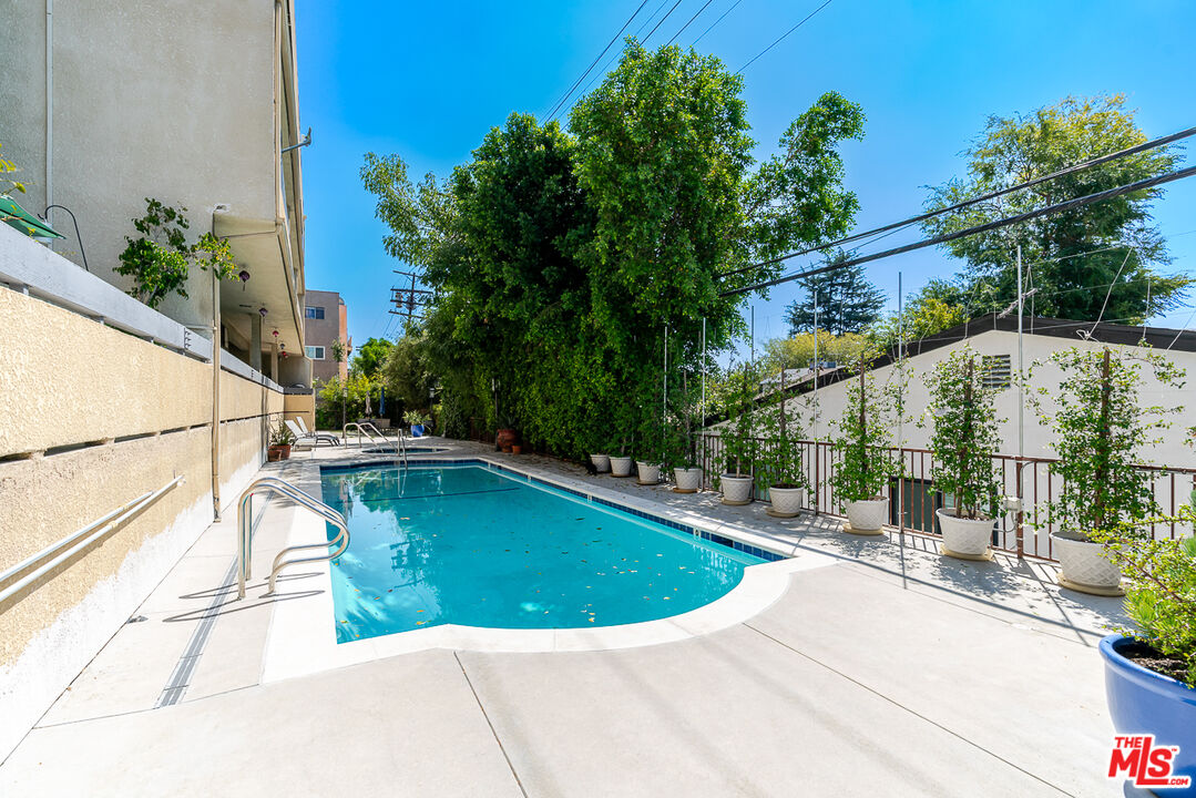 11322 Camarillo Street, Unit 201 Toluca Lake, CA 91602 - Photo 19 of 20 a view of a swimming pool with a patio