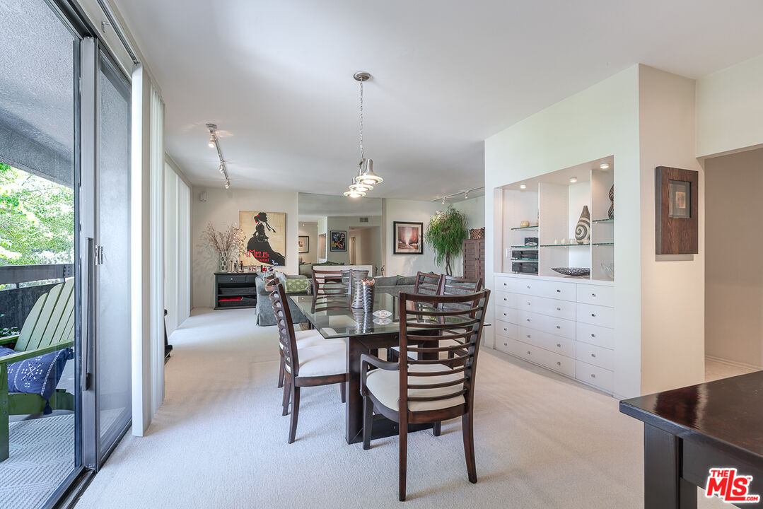 11322 Camarillo Street, Unit 201 Toluca Lake, CA 91602 - Photo 7 of 20 a view of a dining room with furniture and a kitchen