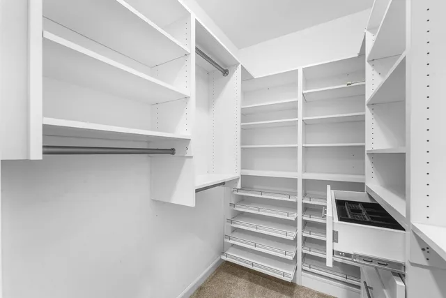 an empty room with a window and a ceiling fan