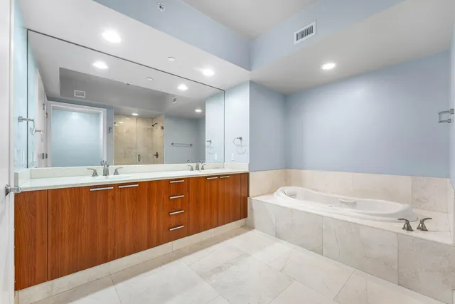 a view of a big room with windows and chandelier