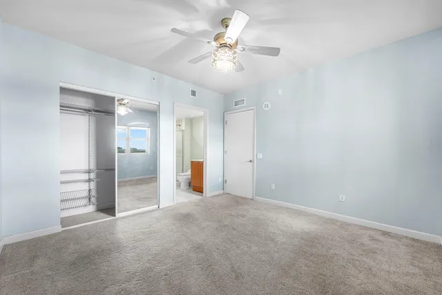 an empty room with a chandelier fan