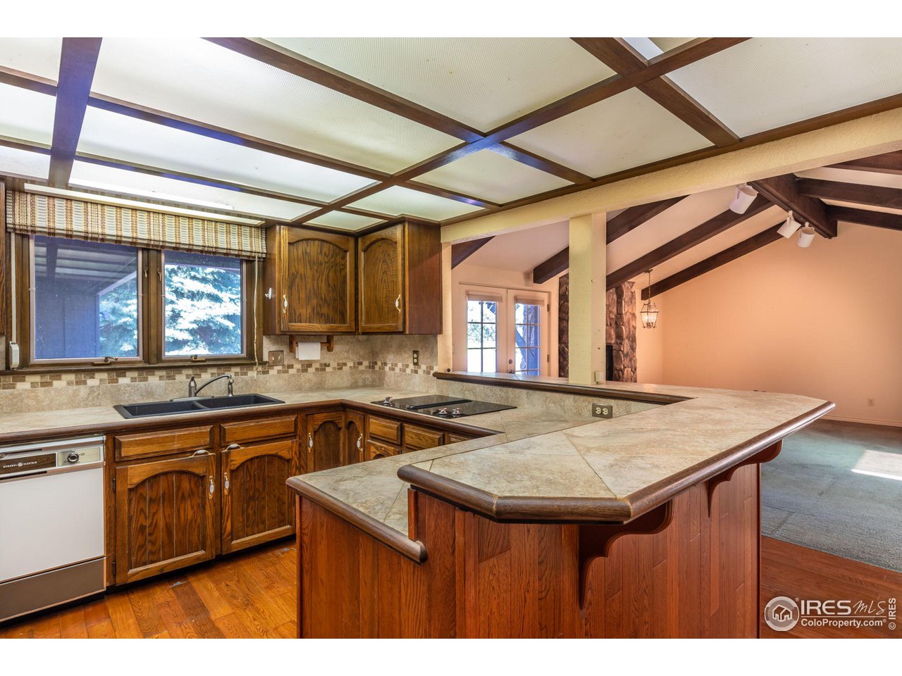 7125 Four Rivers Road Boulder, CO 80301 - Photo 14 of 40 a kitchen with a sink a stove cabinets and wooden floor