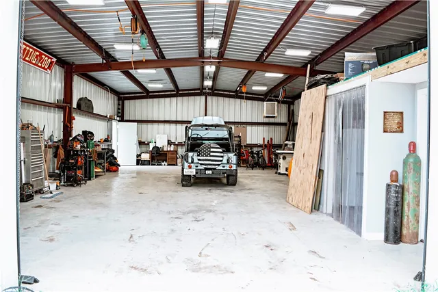 a view of a house with a backyard and trees